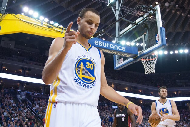 January 14, 2015; Oakland, CA, USA; Golden State Warriors guard Stephen Curry (30) celebrates after a basket against the Miami Heat during the third quarter at Oracle Arena. The Warriors defeated the Heat 104-89. Mandatory Credit: Kyle Terada-USA TODAY Sports