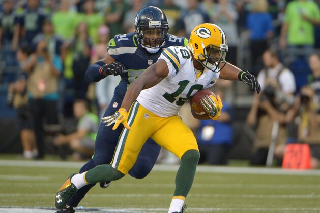 Sep 4, 2014; Seattle, WA, USA; Seattle Seahawks linebacker Bobby Wagner (54) tackles Green Bay Packers receiver Randall Cobb (18) at CenturyLink Field. The Seahawks defeated the Packers 36-16. Mandatory Credit: Kirby Lee-USA TODAY Sports