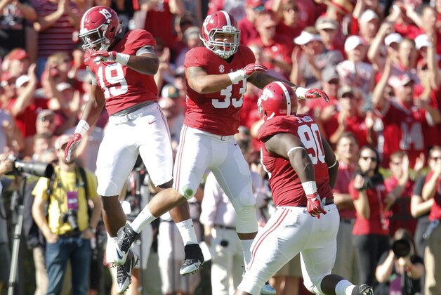 Oct 18, 2014; Tuscaloosa, AL, USA; Alabama Crimson Tide linebacker Reggie Ragland (19) and linebacker Trey DePriest (33) celebrate after a play during the game against the Texas A&M Aggies at Bryant-Denny Stadium. Mandatory Credit: Marvin Gentry-USA TODAY Sports