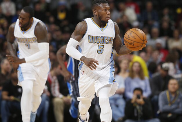 Denver Nuggets guard Nate Robinson brings the ball up the court against the Orlando Magic in the first quarter of an NBA basketball game Wednesday, Jan. 7, 2015, in Denver. (AP Photo/David Zalubowski)
