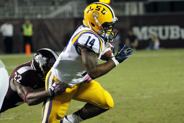 LSU running back Terrence Magee (14) is tackled by Mississippi State linebacker Matthew Wells (22) in the second half of their NCAA college football game in Starkville, Miss., Saturday, Oct. 5, 2013. No. 10 LSU won 59-26.  (AP Photo/Rogelio V. Solis)