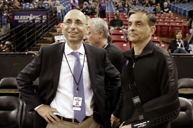 Sacramento Kings General Manager Pete D'Alessandro, left, talks with Kings majority owner Vivek Ranadive before an NBA basketball game against the Los Angeles Clippers in Sacramento, Calif., Friday, Nov. 1, 2013.(AP Photo/Rich Pedroncelli)