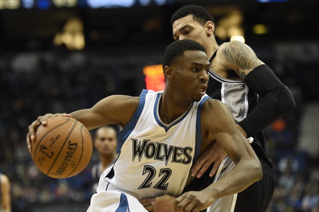Minnesota Timberwolves forward Andrew Wiggins (22) drives against San Antonio Spurs guard Danny Green (14) during the fourth quarter of an NBA basketball game Saturday, Jan. 10, 2015, in Minneapolis. The Spurs won 108-93. (AP Photo/Hannah Foslien)