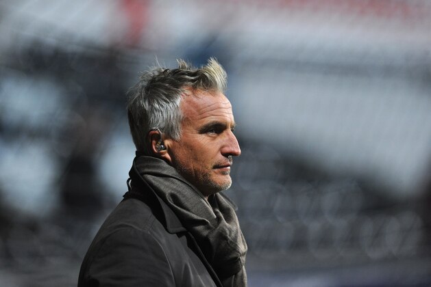 SWANSEA, WALES - DECEMBER 04:  TV pundit David Ginola looks on before the Barclays Premier League match between Swansea City and Newcastle United at the Liberty Stadium on December 4, 2013 in Swansea, Wales.  (Photo by Stu Forster/Getty Images)