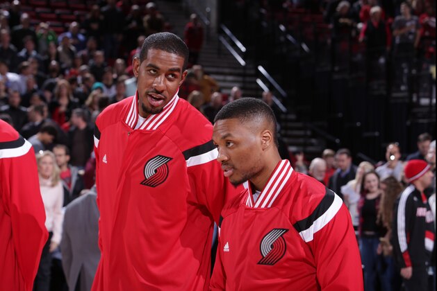 PORTLAND, OR - DECEMBER 4: LaMarcus Aldridge #12 and Damian Lillard #0 of the Portland Trail Blazers stand for the national anthem before a game against the Indiana Pacers on December 4, 2014 at the Moda Center Arena in Portland, Oregon. NOTE TO USER: User expressly acknowledges and agrees that, by downloading and or using this photograph, user is consenting to the terms and conditions of the Getty Images License Agreement. Mandatory Copyright Notice: Copyright 2014 NBAE (Photo by Sam Forencich/NBAE via Getty Images)