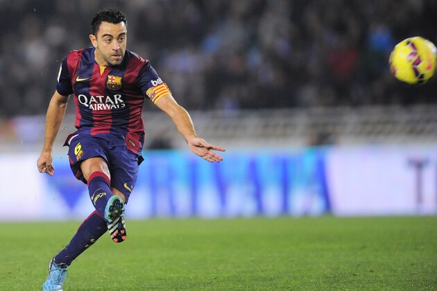 Barcelona's Xavi Hernandez, kicks the ball during their La Liga soccer match between Real Sociedad and Barcelona, at Anoeta stadium in San Sebastian, northern Spain, Sunday, Jan.4, 2015. Barcelona lost the match 1-0. (AP Photo/Alvaro Barrientos)
