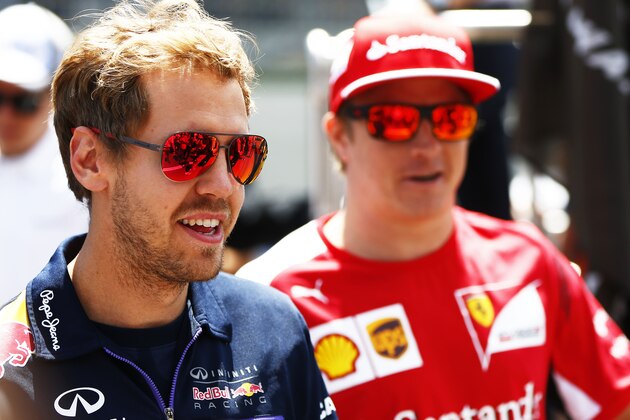 SPIELBERG, STYRIA - JUNE 22:  Sebastian Vettel of Germany and Infiniti Red Bull Racing speaks with Kimi Raikkonen of Finland and Ferrari during the drivers' parade ahead of the Austrian Formula One Grand Prix at Red Bull Ring on June 22, 2014 in Spielberg, Austria.  (Photo by Andrew Hone/Getty Images)