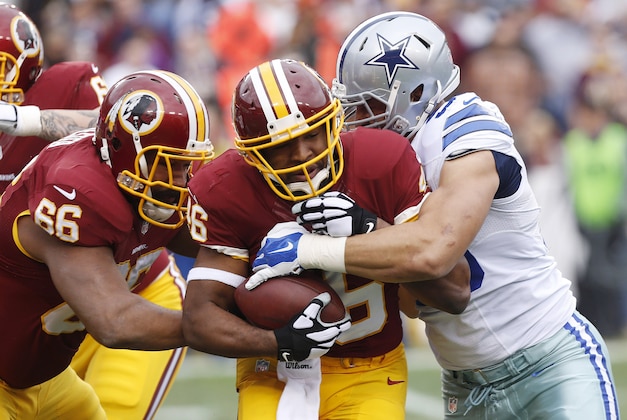 Dec 28, 2014; Landover, MD, USA; Washington Redskins running back Alfred Morris (46) carries the ball as Dallas Cowboys defensive tackle Tyrone Crawford (98) defends in the first quarter at FedEx Field. Mandatory Credit: Geoff Burke-USA TODAY Sports