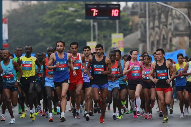 Competitors run during the Mumbai Marathon in Mumbai, India, Sunday, Jan. 19, 2014. Thousands of city residents alongside athletes took part in the event. (AP Photo/Rafiq Maqbool)