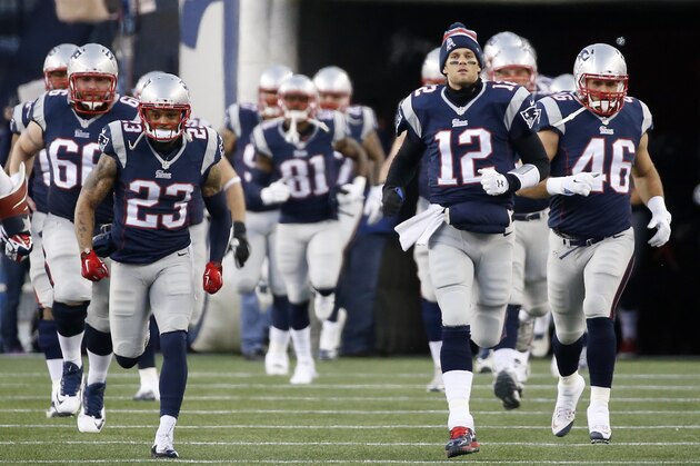 New England Patriots quarterback Tom Brady (12)  leads his team on the field before an NFL divisional playoff football game against the Baltimore Ravens Saturday, Jan. 10, 2015, in Foxborough, Mass. (AP Photo/Elise Amendola)