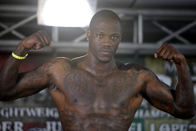 WBC Continental Americas Heavyweight Champion Deontay Wilder poses for photos as he makes weight during the official weigh-in at the Ruben Rodriguez Coliseum in Bayamon, Puerto Rico, Friday, March 14, 2014. Wilder will face defend his title against Malik Scott in a Showtime Championship Boxing match Saturday. (AP Photo/Ricardo Arduengo)