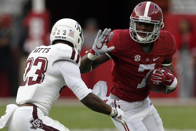 Alabama wide receiver Cam Sims (7) tries to get around Texas A&M Armani Watts (23) during the second half of an NCAA college football game on Saturday, Oct. 18, 2014, in Tuscaloosa, Ala. (AP Photo/Butch Dill)
