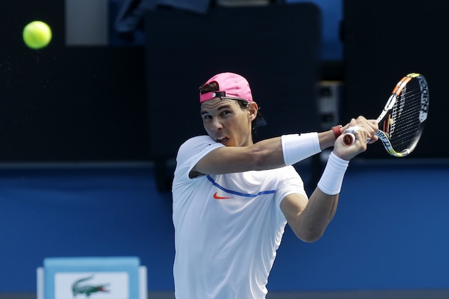 Spain's Rafael Nadal makes a backhand return during a practice session ahead of the Australian Open tennis championship in Melbourne, Australia, Saturday, Jan. 17, 2015. (AP Photo/Mark Baker)