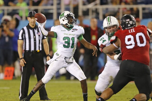 Marshall’s Rakeem Cato (31) throws the ball against Northern Illinois during second half action of the Boca Raton Bowl NCAA college football game on Tuesday, Dec. 23, 2014, at FAU Stadium in Boca Raton, Fla. Marshall defeated Northern Illinois 52-23. (AP Photo/Joel Auerbach)