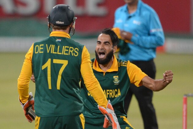DURBAN, SOUTH AFRICA - JANUARY 16: Imran Tahir of the Proteas celebrates the wicket of Dwayne Smith of the West Indies with AB de Villiers of the Proteas during the 1st Momentum ODI between South Africa and West Indies at Sahara Stadium Kingsmead on January 16, 2015 in Durban, South Africa. (Photo by Lee Warren/Gallo Images)