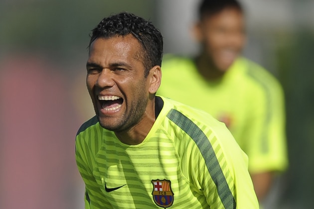 FC Barcelona's Dani Alves, from Brazil, laughs during a training session at the Sports Center FC Barcelona Joan Gamper in San Joan Despi, Spain, Monday, Oct. 20, 2014. FC Barcelona will play against Ajax in a group F Champions League on Tuesday Oct. 21. (AP Photo/Manu Fernandez)