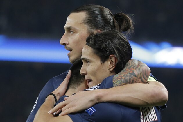 PSG's Edinson Cavani, right, celebrates his opening goal with Zlatan Ibrahimovic, top, and Ezequiel Lavezzi during the Champions League Group F soccer match between Paris Saint Germain and Ajax at Parc des Princes stadium in Paris, France, Tuesday, Nov. 25, 2014. (AP Photo/Francois Mori)
