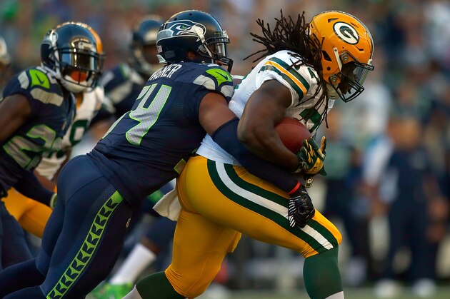 SEATTLE, WA - SEPTEMBER 04:  Running back Eddie Lacy #27  of the Green Bay Packers is brought down by linebacker Bobby Wagner #54 of the Seattle Seahawks during the first quarter of the game at CenturyLink Field on September 4, 2014 in Seattle, Washington.  (Photo by Jonathan Ferrey/Getty Images)