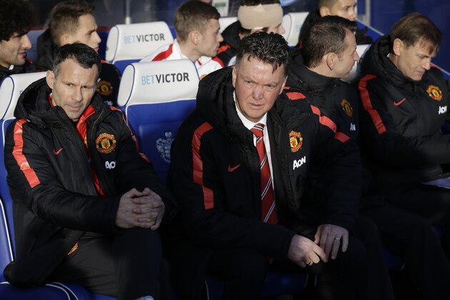 Manchester United's manager Louis van Gaal, second left, and coach Ryan Giggs, left, wait for the start of the English Premier League soccer match between QPR and Manchester United at Loftus Road stadium in London, Saturday, Jan. 17, 2015.  (AP Photo/Matt Dunham)