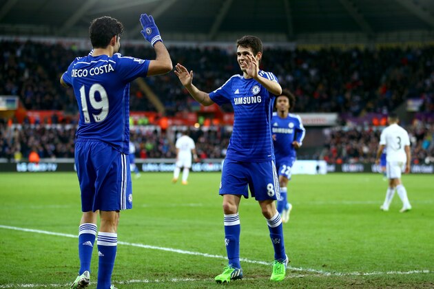 SWANSEA, WALES - JANUARY 17:  Oscar of Chelsea celebrates with Diego Costa of Chelsea after scoring his team's fourth goal during the Barclays Premier League match between Swansea City and Chelsea at Liberty Stadium on January 17, 2015 in Swansea, Wales.  (Photo by Richard Heathcote/Getty Images)