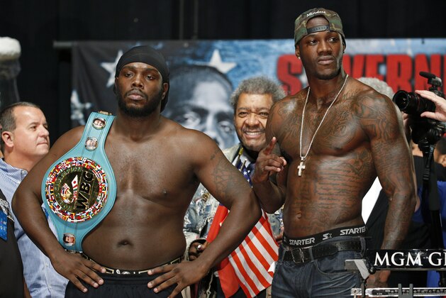 Bermane Stiverne, left, and Deontay Wilder pose for photographers during their weigh-in Friday, Jan. 16, 2015, in Las Vegas. The two are scheduled to fight in a WBC heavyweight title bout on Saturday in Las Vegas. (AP Photo/John Locher)