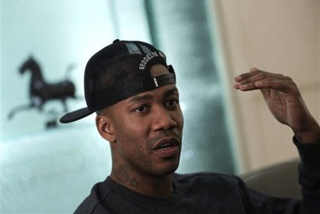 In this Nov. 18, 2014 photo, U.S. basketball player Stephon Marbury speaks during an interview in the lobby of his plush apartment building in Beijing. After a tumultuous career in the NBA, Marbury says he’s found a new peace in China, thriving on the court with the Beijing Ducks and mentoring young Chinese teammates. (AP Photo/Andy Wong)