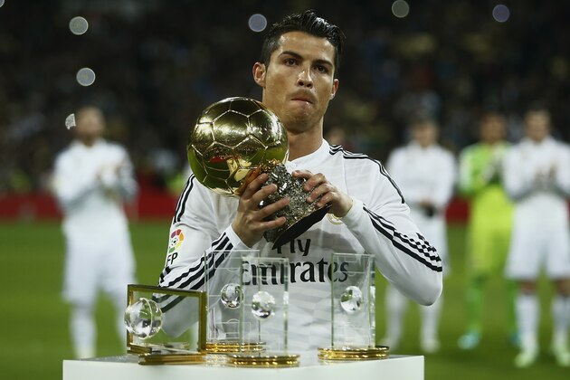 Real Madrid's Cristiano Ronaldo from Portugal holds the Balon D'Or trophy before a King's Cup soccer match between Atletico de Madrid and Real Madrid at the Santiago Bernabeu stadium in Madrid, Spain, Thursday, Jan. 15, 2015. (AP Photo/Andres Kudacki)
