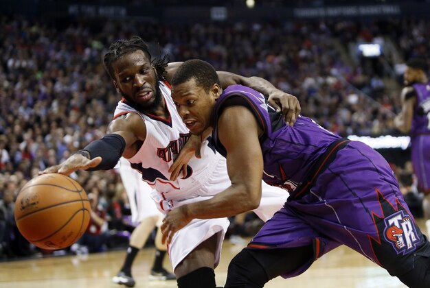 Jan 16, 2015; Toronto, Ontario, CAN; Atlanta Hawks forward DeMarre Carroll (5) and Toronto Raptors guard Kyle Lowry (7) battle for the ball during the first half at the Air Canada Centre. Mandatory Credit: John E. Sokolowski-USA TODAY Sports