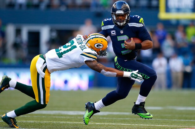 SEATTLE - SEPTEMBER 04:  Quaterback Russell Wilson #3 of the Seattle Seahawks escapes the tackle attempt of safety Ha Ha Clinton-Dix #21 of the Green Bay Packers at CenturyLink Field on September 4, 2014 in Seattle, Washington.  (Photo by Jonathan Ferrey/Getty Images)