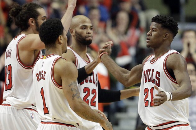 Chicago Bulls guard/forward Jimmy Butler (21) celebrates with guard Derrick Rose (1), center/forward Joakim Noah (13) and forward Taj Gibson (22) after scoring a basket during the second half of an NBA basketball game against the New Orleans Pelicans in Chicago on Saturday, Dec. 27, 2014. The Bulls won 107-100. (AP Photo/Nam Y. Huh)