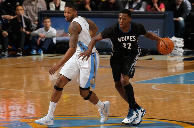 DENVER, CO - JANUARY 17:  Andrew Wiggins #22 of the Minnesota Timberwolves controls the ball against Alonzo Gee #1 of the Denver Nuggets at Pepsi Center on January 17, 2015 in Denver, Colorado. The Timberwolves defeated the Nuggets 113-105. NOTE TO USER: User expressly acknowledges and agrees that, by downloading and or using this photograph, User is consenting to the terms and conditions of the Getty Images License Agreement.  (Photo by Doug Pensinger/Getty Images)