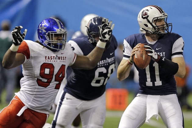 East defensive lineman Za'Darius Smith (94), of Kentucky, chases West quarterback Dylan Thompson (11), of South Carolina, during the second quarter of the East-West Shrine college football game Saturday, Jan. 17, 2015, in St. Petersburg, Fla. (AP Photo/Chris O'Meara)