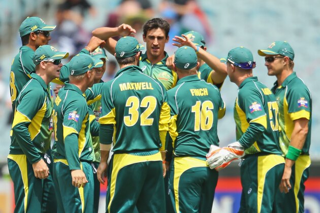 MELBOURNE, AUSTRALIA - JANUARY 18:  Mitchell Starc of Australia celebrates with his teammates after dismissing Shikhar Dhawan of India during the One Day International match between Australia and India at the Melbourne Cricket Ground on January 18, 2015 in Melbourne, Australia.  (Photo by Scott Barbour/Getty Images)