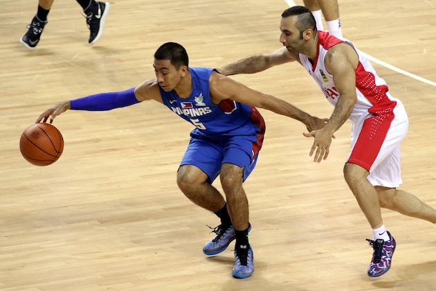 INCHEON, SOUTH KOREA - SEPTEMBER 25:  Mahdi Kamrani of Iran and Lewis Alfred Tenorio of the Philippines competes during the Basketball Mens Preliminary round match between Iran and the Philippines during day five of the 2014 Asian Games at Hwaseong Sports Complex Gymnasium on September 25, 2014 in Incheon, South Korea.  (Photo by Stanley Chou/Getty Images)