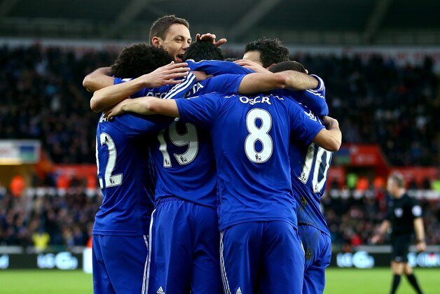 SWANSEA, WALES - JANUARY 17:  Oscar of Chelsea celebrates with team-mates after scoring his team's fourth goal during the Barclays Premier League match between Swansea City and Chelsea at Liberty Stadium on January 17, 2015 in Swansea, Wales.  (Photo by Richard Heathcote/Getty Images)