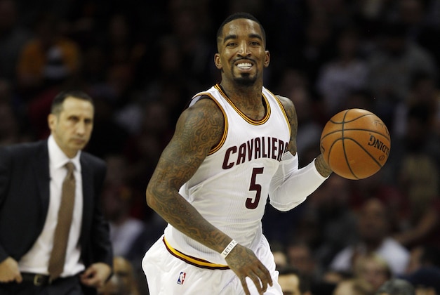 CLEVELAND, OH - JANUARY 7:  J.R. Smith #5 of the Cleveland Cavaliers advances the ball up court as Cavaliers Head Coach Dave Blatt looks on against the Houston Rockets during the second half of their game on January 7, 2015 at Quicken Loans Arena  in Cleveland, Ohio.  the Rockets defeated the Cavaliers 105-93.  NOTE TO USER: User expressly acknowledges and agrees that, by downloading and or using this photograph, User is consenting to the terms and conditions of the Getty Images License Agreement. (Photo by David Maxwell/Getty Images)