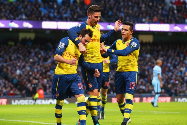 MANCHESTER, ENGLAND - JANUARY 18:  Santi Cazorla of Arsenal (L) celebrates with Olivier Giroud (C) and Alexis Sanchez as he scores their first goal from a penalty during the Barclays Premier League match between Manchester City and Arsenal at Etihad Stadium on January 18, 2015 in Manchester, England.  (Photo by Alex Livesey/Getty Images)