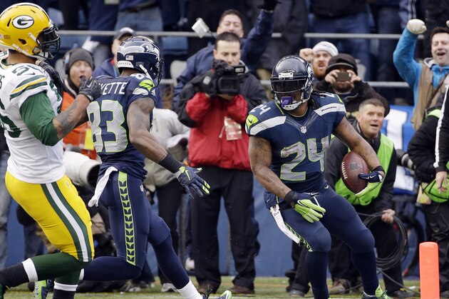 Seattle Seahawks' Marshawn Lynch (24) runs into the end zone for a touchdown during the second half of the NFL football NFC Championship game against the Green Bay Packers Sunday, Jan. 18, 2015, in Seattle. (AP Photo/David J. Phillip)