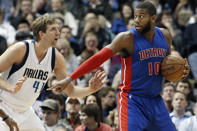 Detroit Pistons forward Greg Monroe (10) signals to a teammate as Dallas Mavericks forward Dirk Nowitzki (41) defends during the second half of an NBA basketball game, Wednesday, Jan. 7, 2015 in Dallas. Detroit won 108-95. (AP Photo/Brandon Wade)
