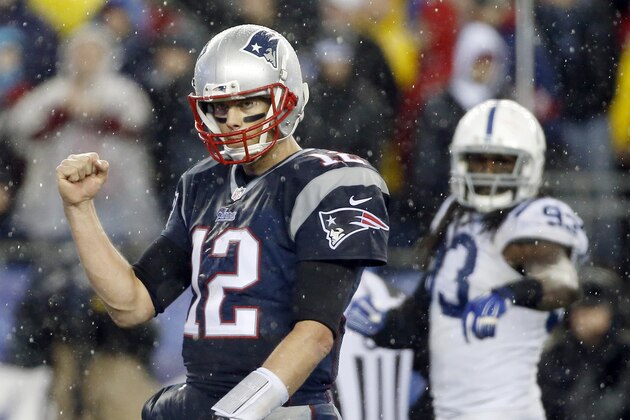 New England Patriots quarterback Tom Brady (12) celebrates LeGarrette Blount's touchdown during the second half of the NFL football AFC Championship game against the Indianapolis Colts Sunday, Jan. 18, 2015, in Foxborough, Mass. (AP Photo/Elise Amendola)