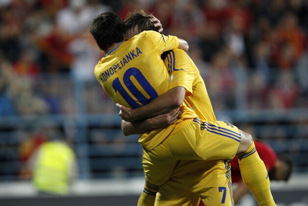 Ukraine's Yevhen Konoplyanka, left celebrates a goal with Andriy Yarmolenko during their World Cup group H qualifying soccer match at City Stadium in Podgorica, Montenegro, Friday, June 7, 2013. (AP Photo/Darko Vojinovic)