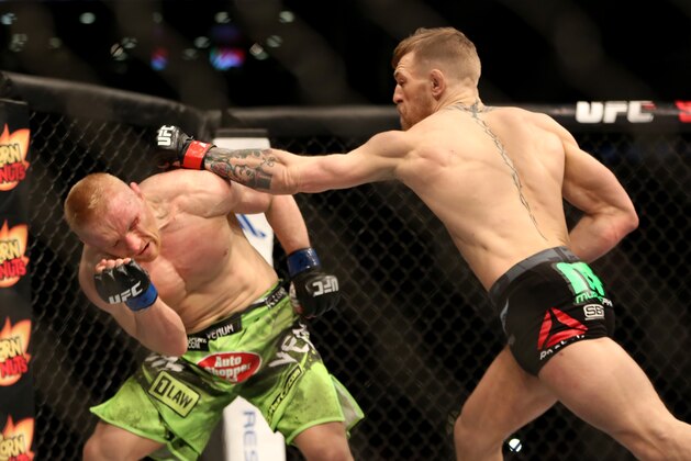 Conor McGregor, of Ireland, right, in action against Dennis Siver, of Germany, during their featherweight fight at UFC Fight Night, Sunday, January 18, 2015 in Boston.  McGregor won via 2nd round TKO. (AP Photo/Gregory Payan)