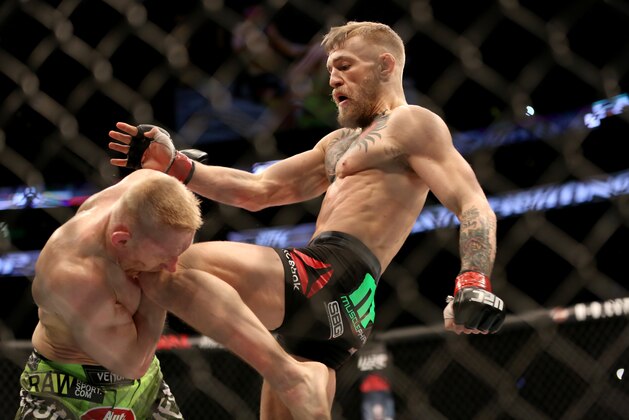 Conor McGregor, of Ireland,  lands a knee against Dennis Siver, of Germany, during their featherweight fight at UFC Fight Night, Sunday, Jan. 18, 2015 in Boston.  McGregor won via 2nd round TKO. (AP Photo/Gregory Payan)