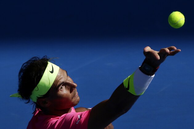 Rafael Nadal of Spain serves to Mikhail Youzhny of Russia during their first round match at the Australian Open tennis championship in Melbourne, Australia, Monday, Jan. 19, 2015. (AP Photo/Bernat Armangue)