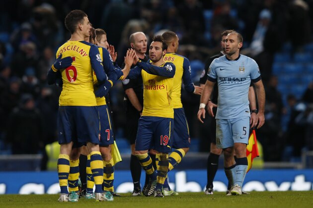 Arsenal's Santi Cazorla, second right No19, celebrates with his teammates at the end of the English Premier League soccer match between Manchester City and Arsenal at the Etihad Stadium, Manchester, England, Sunday, Jan. 18, 2015. Arsenal won the match 2-0, with Cazorla and his teammate Arsenal's Olivier Giroud scoring the goal.(AP Photo/Jon Super)