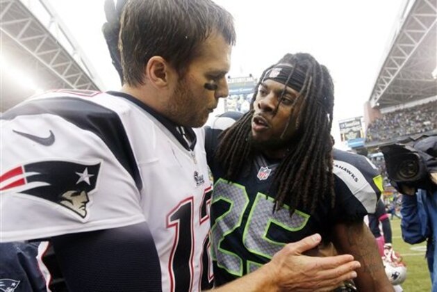 Seattle Seahawks' Richard Sherman (25) talks with New England Patriots quarterback Tom Brady after an NFL football game, Sunday, Oct. 14, 2012, in Seattle. The Seahawks won 24-23. (AP Photo/Elaine Thompson)