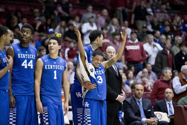 Kentucky center Dakari Johnson (44), Kentucky guard Devin Booker (1) and Kentucky guard Tyler Ulis (3) celebrate their win during the second half of an NCAA college basketball game against Alabama, Saturday, Jan. 17, 2015, in Tuscaloosa, Ala. Kentucky won 70-48. (AP Photo/Brynn Anderson)