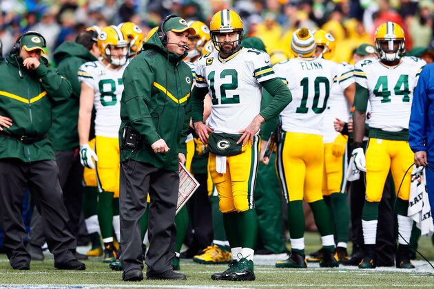 SEATTLE, WA - JANUARY 18:  Aaron Rodgers #12 speaks with head coach Mike McCarthy of the Green Bay Packers during the 2015 NFC Championship game against the Seattle Seahawks at CenturyLink Field on January 18, 2015 in Seattle, Washington.  (Photo by Kevin C. Cox/Getty Images)