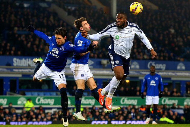 LIVERPOOL, ENGLAND - JANUARY 19:  Victor Anichebe of West Brom jumps for the ball under pressure from Seamus Coleman and Muhamed Besic of Everton during the Barclays Premier League match between Everton and West Bromwich Albion at Goodison Park on January 19, 2015 in Liverpool, England.  (Photo by Alex Livesey/Getty Images)