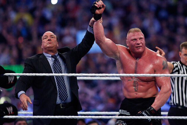 Paul Heyman, left, celebrates with Brock Lesnar after his win over the Undertaker  during Wrestlemania XXX at the Mercedes-Benz Super Dome in New Orleans on Sunday, April 6, 2014. (Jonathan Bachman/AP Images for WWE)